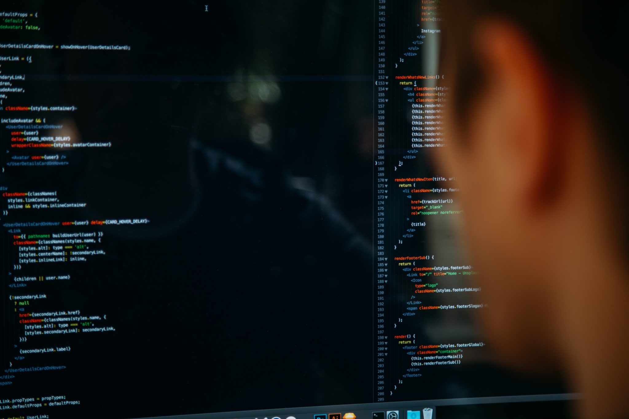 man in front of coding on screen