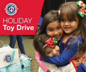 3 little girls hugging at the holiday toy drive