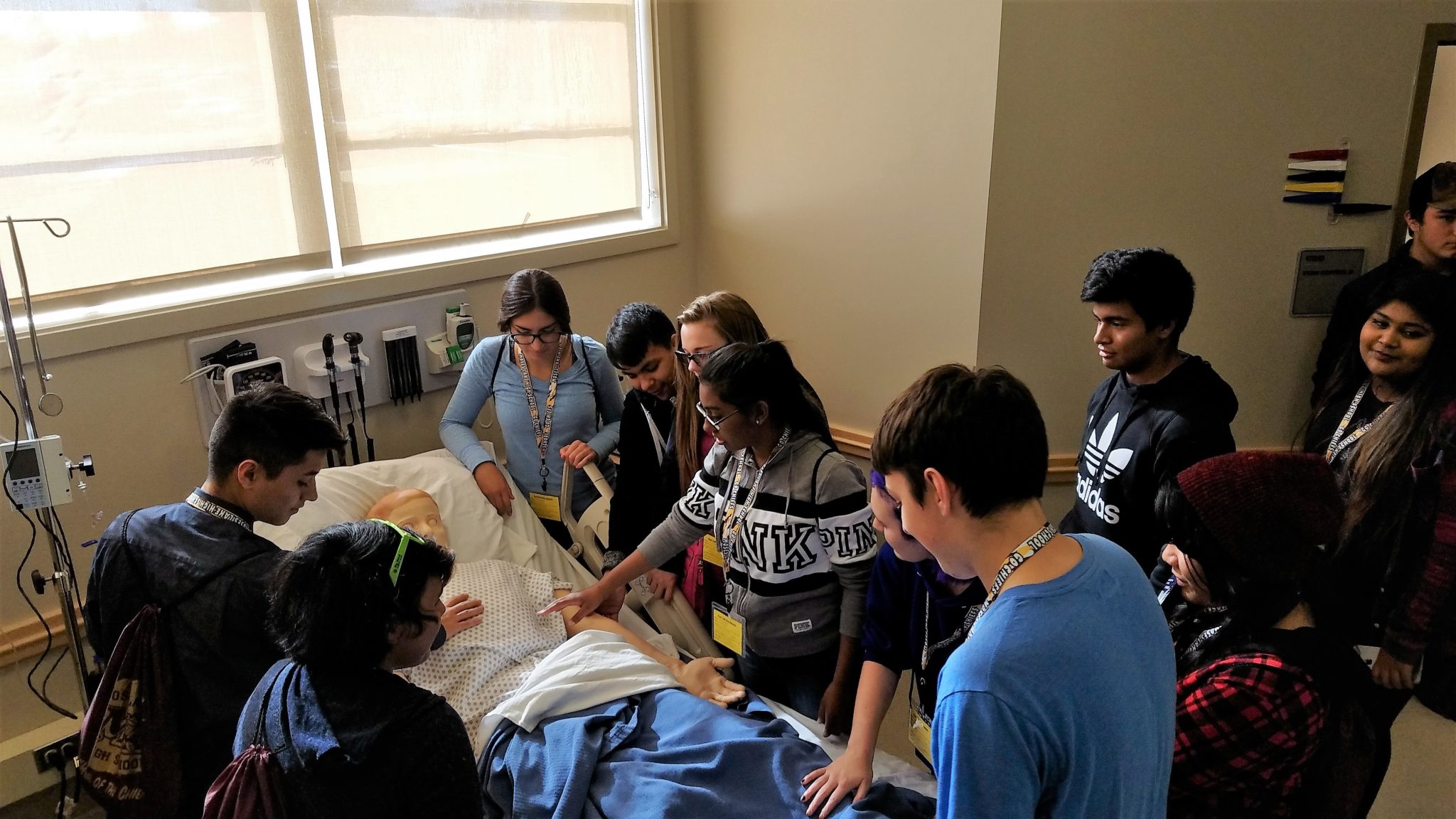 students around manikin in sim lab