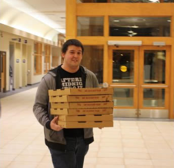 Student carrying pizza