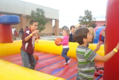 Kids at inflatable basketball hoop