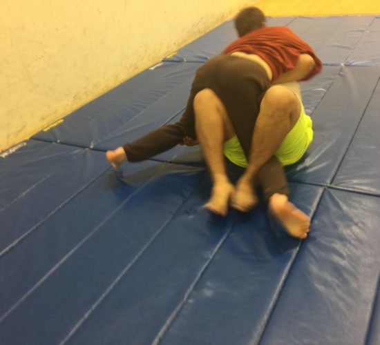 Jiu-Jitsu club members rolling on mats