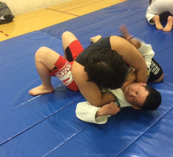 Jiu-Jitsu club members rolling on mats