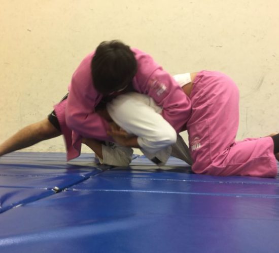 Jiu-Jitsu club members rolling on mats