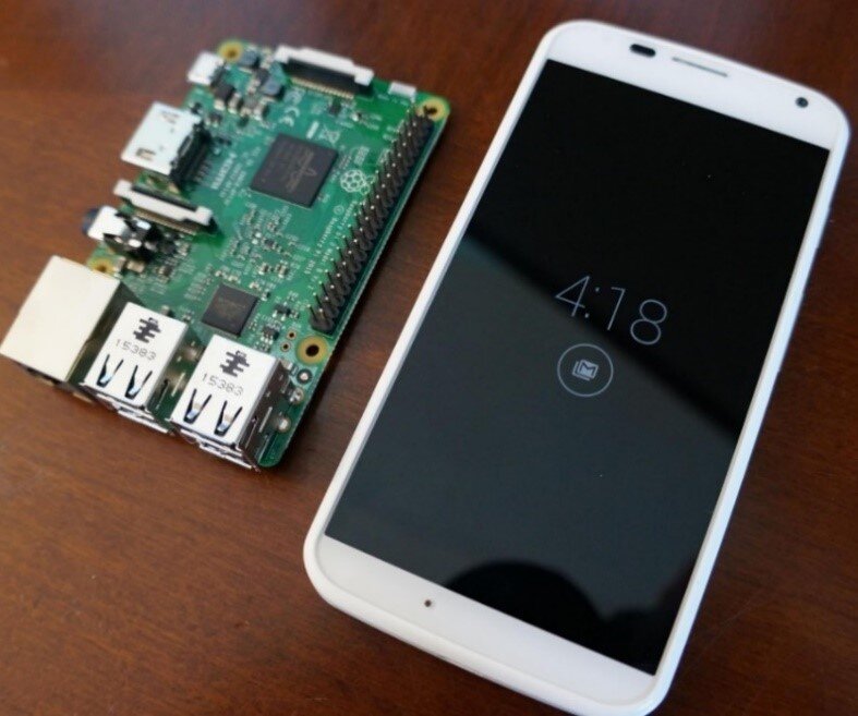 Raspberry Pi device next to smartphone
