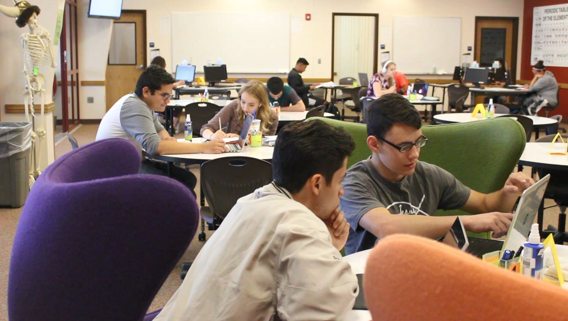 students studying at table in stem center