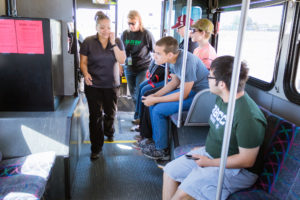 students and adults on bus
