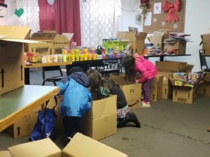 children going through boxes filled with toys